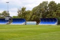 Empty football field with blue stands