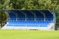 Empty football field with blue stands