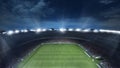 Empty football field with flashlights and dark night sky background. Stadium with filled stands with sports soccer fans. Royalty Free Stock Photo