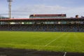 An empty football field. Soccer field grass. Graphite running road track with white marking lines near green football Royalty Free Stock Photo