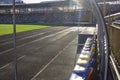 An empty football field. Soccer field grass. Graphite running road track with white marking lines near green football Royalty Free Stock Photo