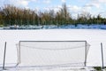 Empty football field in winter, covered with snow Royalty Free Stock Photo