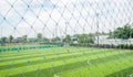 Empty football ground with guard net in cloudy summer