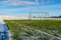 Empty Football & x28;Soccer& x29; Field in the Winter Partly Covered in Snow - Sunny Winter Day Royalty Free Stock Photo