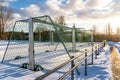 Empty Football (Soccer) Field in the Winter Partly Covered in Snow - Sunny Winter Day Royalty Free Stock Photo