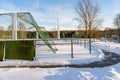 Empty Football (Soccer) Field in the Winter Partly Covered in Snow - Sunny Winter Day Royalty Free Stock Photo