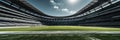 Empty football stadium with lush green field, vast seating under an open sky, wide-angle view Royalty Free Stock Photo