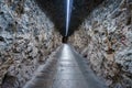 Empty footpath inside illuminated rocky tunnel at Jungfrau railway