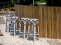 Empty four rattan bar stools, black and white patterns preparing for customer in front of the bamboo bar. Royalty Free Stock Photo