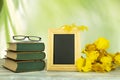 Empty frame with a bouquet of yellow flowers and a pair of glass Royalty Free Stock Photo