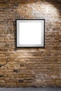 Empty frame on light brick wall. Blank space poster or art frame waiting to be filled. Square Black Frame Mock-Up Royalty Free Stock Photo