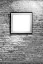 Empty frame on light brick wall. Blank space poster or art frame waiting to be filled. Square Black Frame Mock-Up Royalty Free Stock Photo