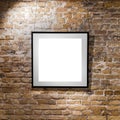 Empty frame on light brick wall. Blank space poster or art frame waiting to be filled. Square Black Frame Mock-Up Royalty Free Stock Photo