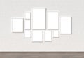 Empty Frame mock ups on white brick wall. 3D illustrating.