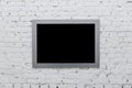 Empty frame from a painting on a white brick wall. Black place mock up Royalty Free Stock Photo