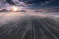 Empty freeway through clouds at idyllic sunrise Royalty Free Stock Photo