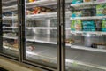 Empty freezer shelves at Publix featuring frozen food shortage including organic vegetables, pizza, and junk food during Covid-19