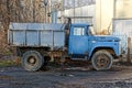 Empty freight old car stands on the streets in the mud Royalty Free Stock Photo