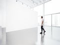 Empty gallery interior with white canvas and young
