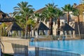 Empty gazebos with sun loungers next to the pool