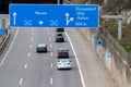 Empty German Autobahn in Dusseldorf with blue street signs and white arrows without traffic jam shows multiple lane highway ready