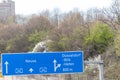 Empty German Autobahn in Dusseldorf with blue street signs and white arrows without traffic jam shows multiple lane highway ready Royalty Free Stock Photo