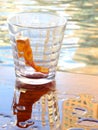 Empty glass of alcohol drink or cocktail have fresh orange slice one piece inside, have water on wood table can see shadow Royalty Free Stock Photo
