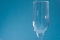 Empty glass on a blue background.A glass for champagne and wine. Royalty Free Stock Photo