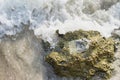 Empty glass bottle washed up as rubbish on a beach, garbage on b Royalty Free Stock Photo