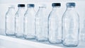 Empty glass bottles in a row on a shelf in blue tone Royalty Free Stock Photo