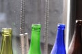 Empty glass bottles standing in a row, green, blue and brown Royalty Free Stock Photo