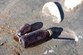 An empty glass bottles washed up on the beach Royalty Free Stock Photo