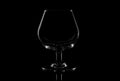 Empty glass brandy glass isolated on a black background