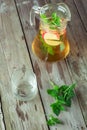 An empty glass and a carafe of green tea with mint and apples Royalty Free Stock Photo