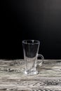 Empty glass goblet. Stands on black pine boards. On a black background Royalty Free Stock Photo