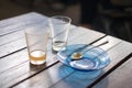 Empty glass of hot tea in with saucer and spoon on wooden table, shallow focus. Royalty Free Stock Photo