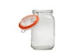 Empty glass jar for bulk products with an open lid on a white background.
