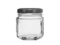 Empty glass jar for jam closed by a black metal cover isolated on a white background Royalty Free Stock Photo