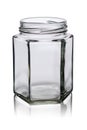 Empty glass jar of a six-sided form with reflection on a white background