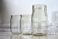 empty glass jars stand on a light floor