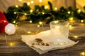 empty glass from milk and crumbs from cookies for Santa Claus in front of a Christmas tree lights bokeh Royalty Free Stock Photo