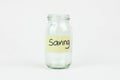 Empty glass money jar with saving label, financial concept.