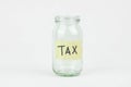 Empty glass money jar with tax label, financial concept. Royalty Free Stock Photo