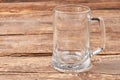 Empty glass mug, wooden table. Royalty Free Stock Photo