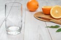Empty glass and oranges in the background Royalty Free Stock Photo