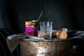 an empty glass and pieces of bread near an open tin can on a rusty barrel Royalty Free Stock Photo