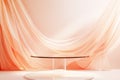 Empty glass table for montage your products on beautiful glowing peach fuzz background with draped textile Royalty Free Stock Photo