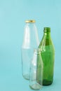 Empty glass transparent and green bottles on a blue background. A copy of the space. Ecology and Zero waste concept Royalty Free Stock Photo