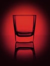 Empty glass for water, whiskey, juice or other drink on a rich dark red gradient background Royalty Free Stock Photo