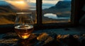 an empty glass of whisky and mountains